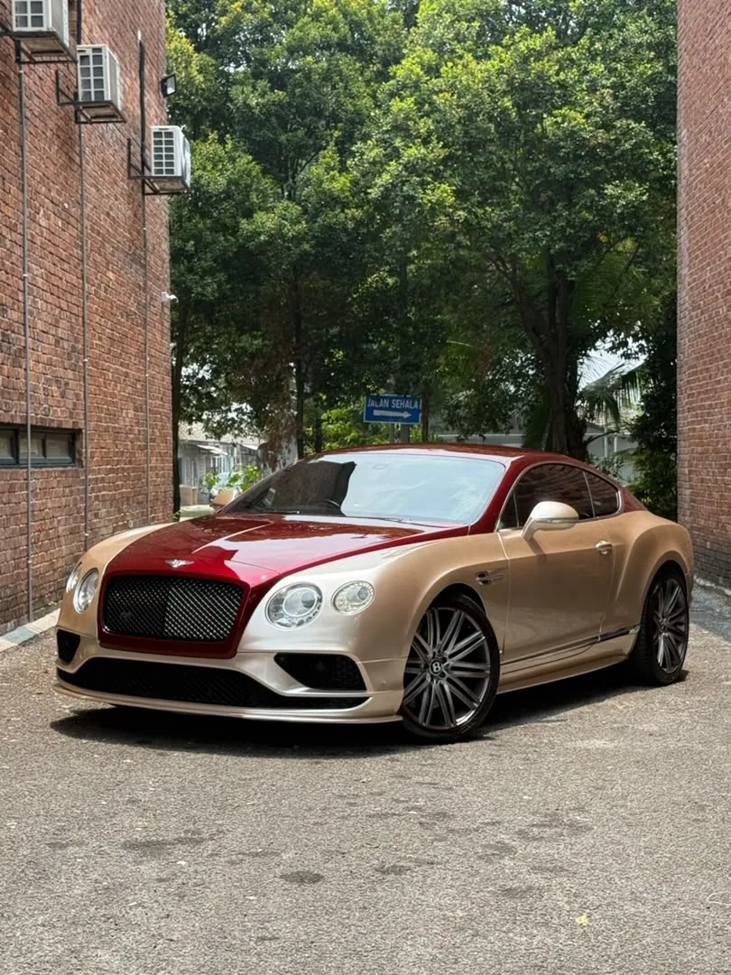 Front angle of gold and maroon wrap on a Bentley Continental GT by Z-Sticker