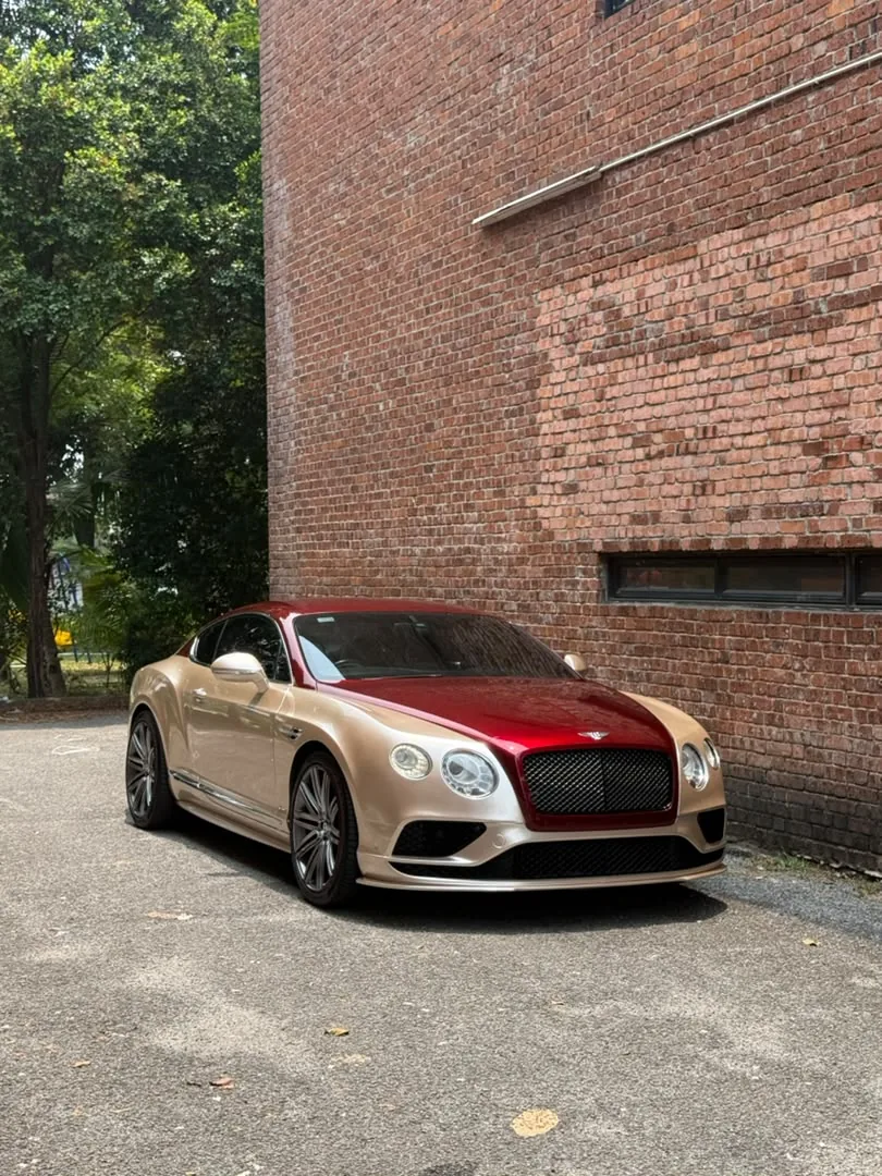 Two-tone gold and maroon wrap on a Bentley Continental GT by Z-Sticker