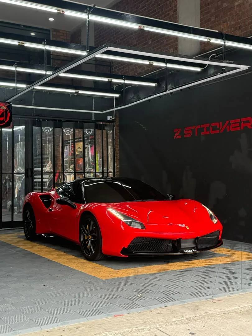Side front view of gloss red wrap on a Ferrari 488 by Z-Sticker