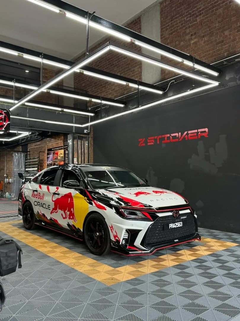 Side view of Red Bull-inspired livery wrap on a Lexus coupe by Z-Sticker