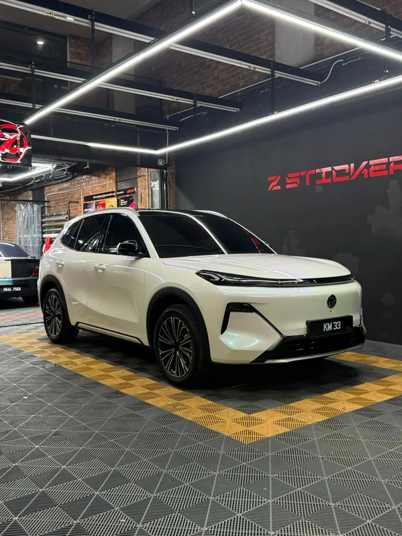 Front angle of pearl white wrap on a Proton electric SUV by Z-Sticker