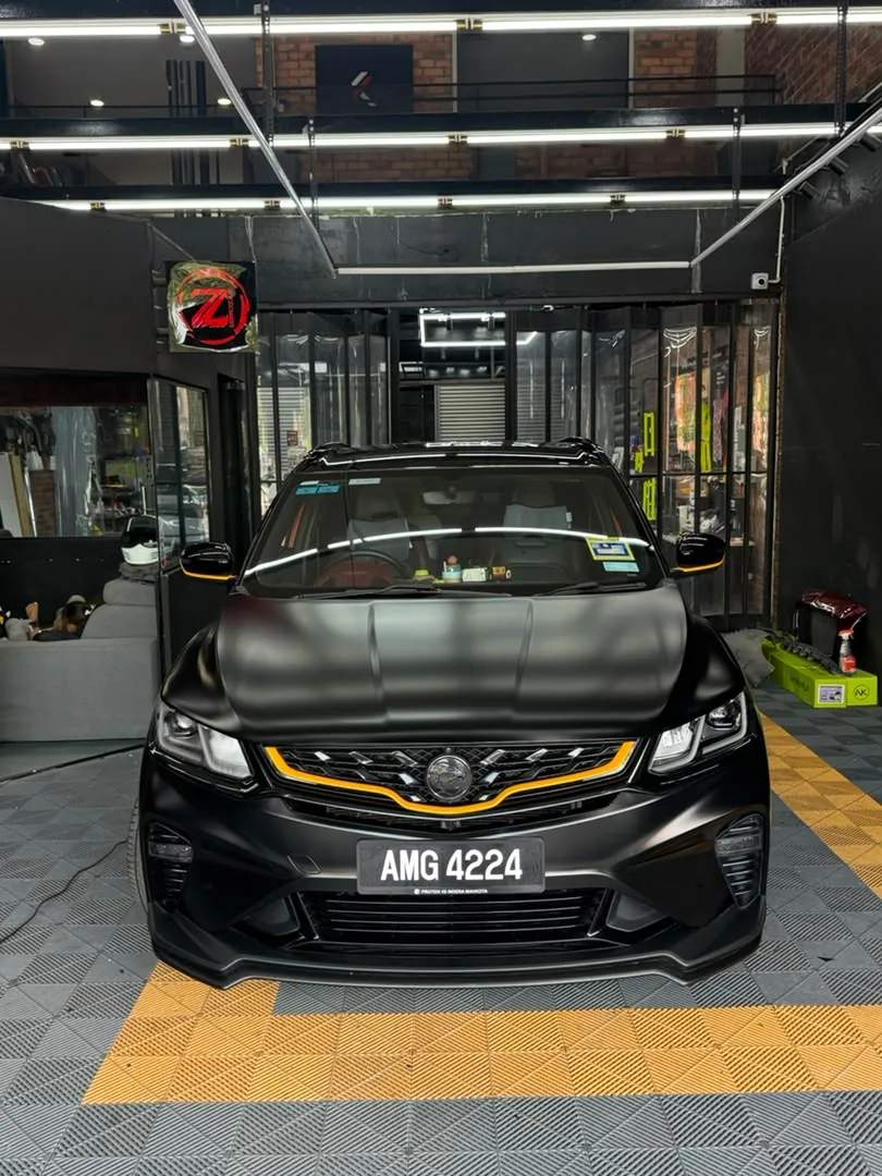 Matte black wrap with gold accents on a Proton X50 by Z-Sticker