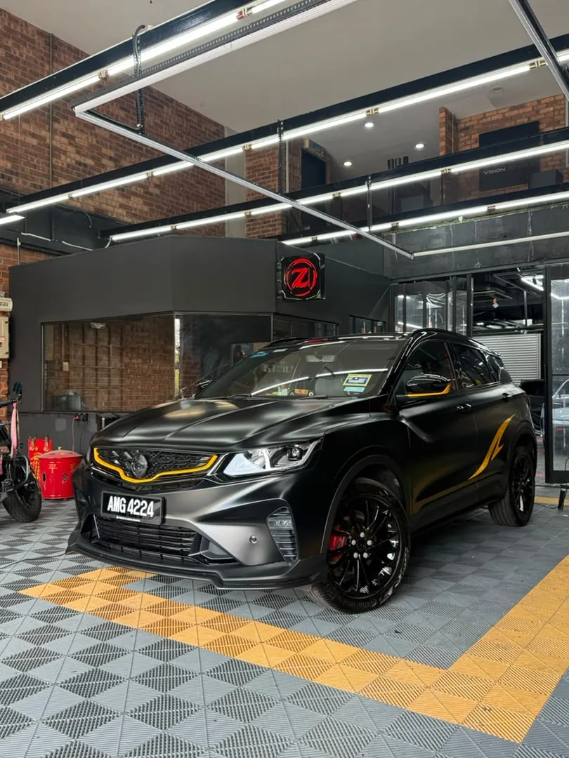 Side angle of black and gold wrap on a Proton X50 by Z-Sticker