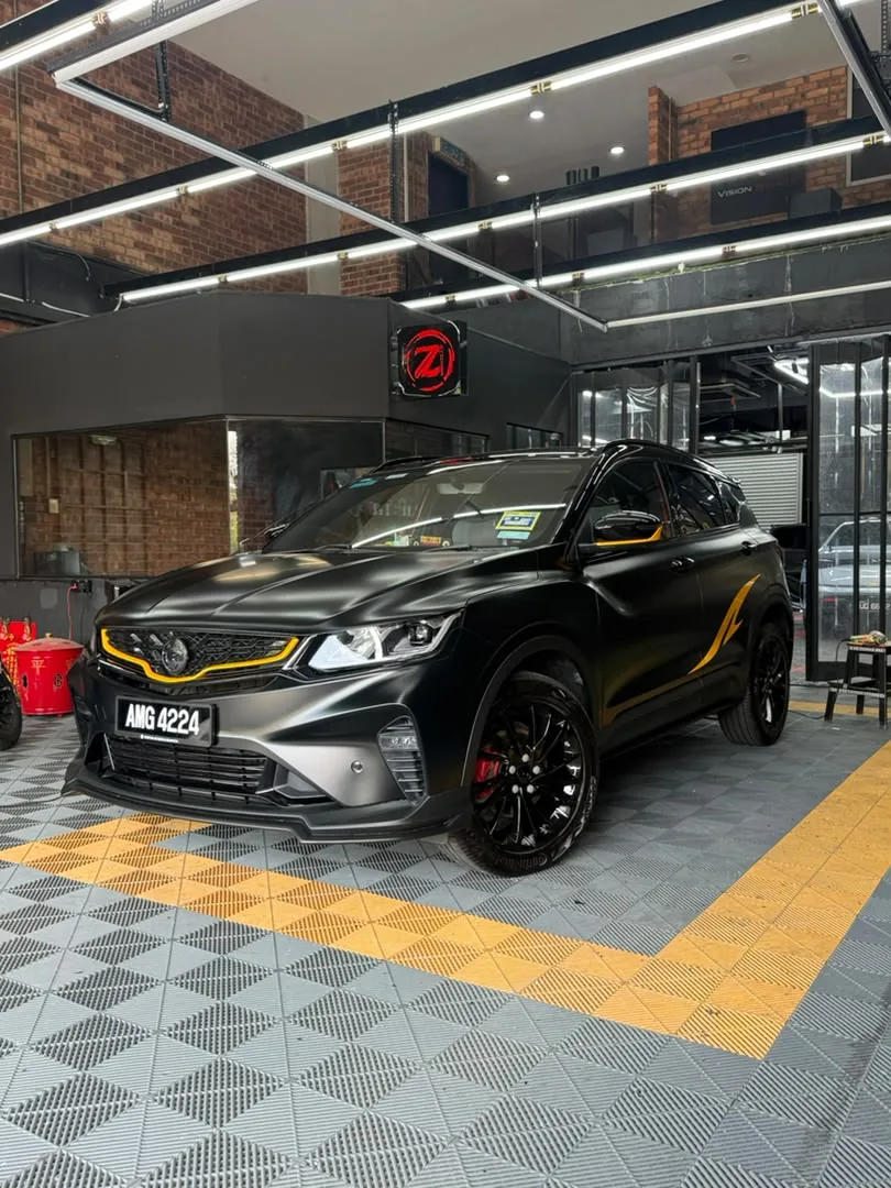 Side view of black and gold wrap on a Proton X50 by Z-Sticker