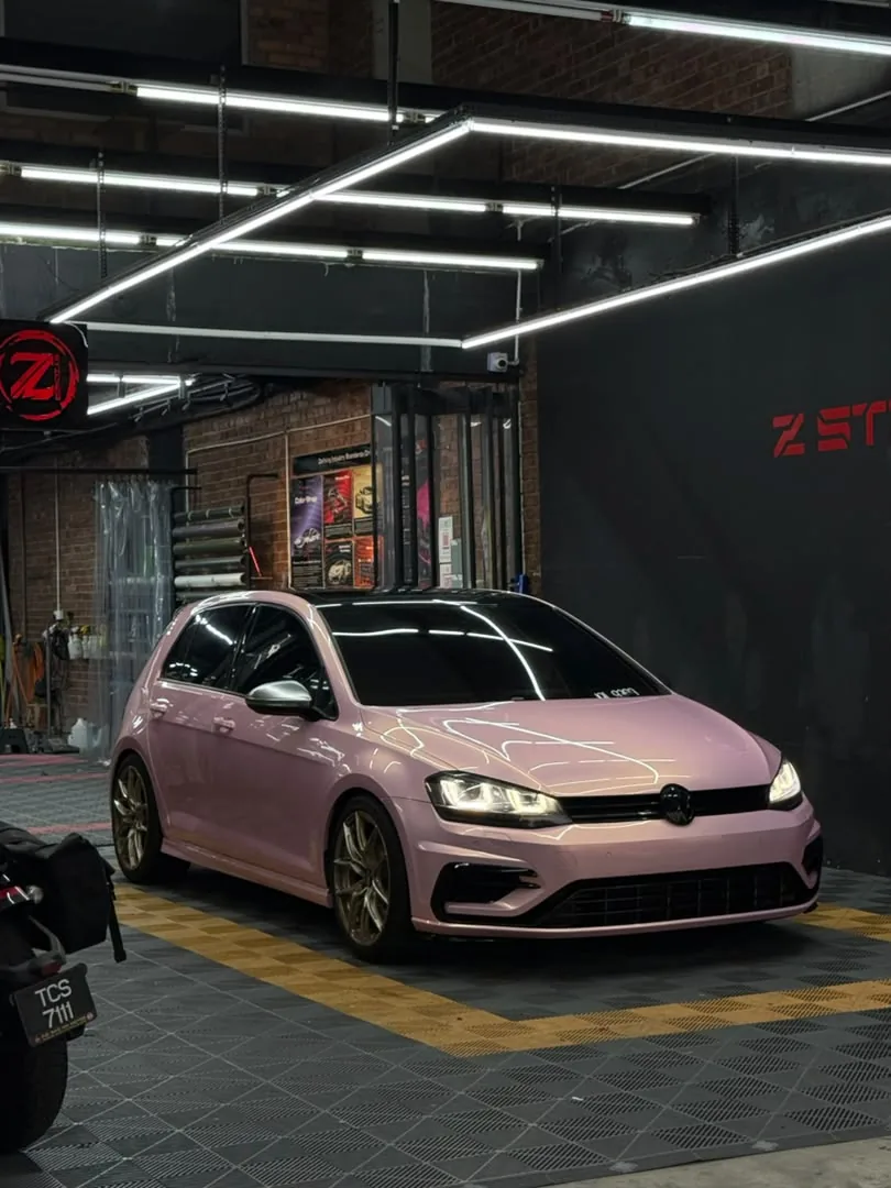 Front side angle of gloss pink wrap on a Volkswagen Golf R by Z-Sticker