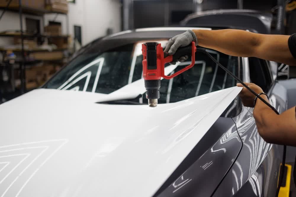 Applying vinyl wrap with heat gun precision